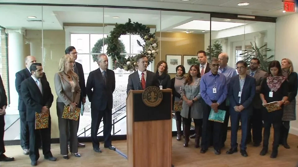 Greater Louisville Inc. President Kent Oyler, center, helped unveil the Global Action Plan